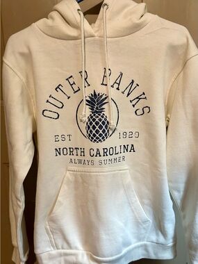 Cream Hooded Sweatshirt with Navy Pineapple Graphic has kangaroo pocket.